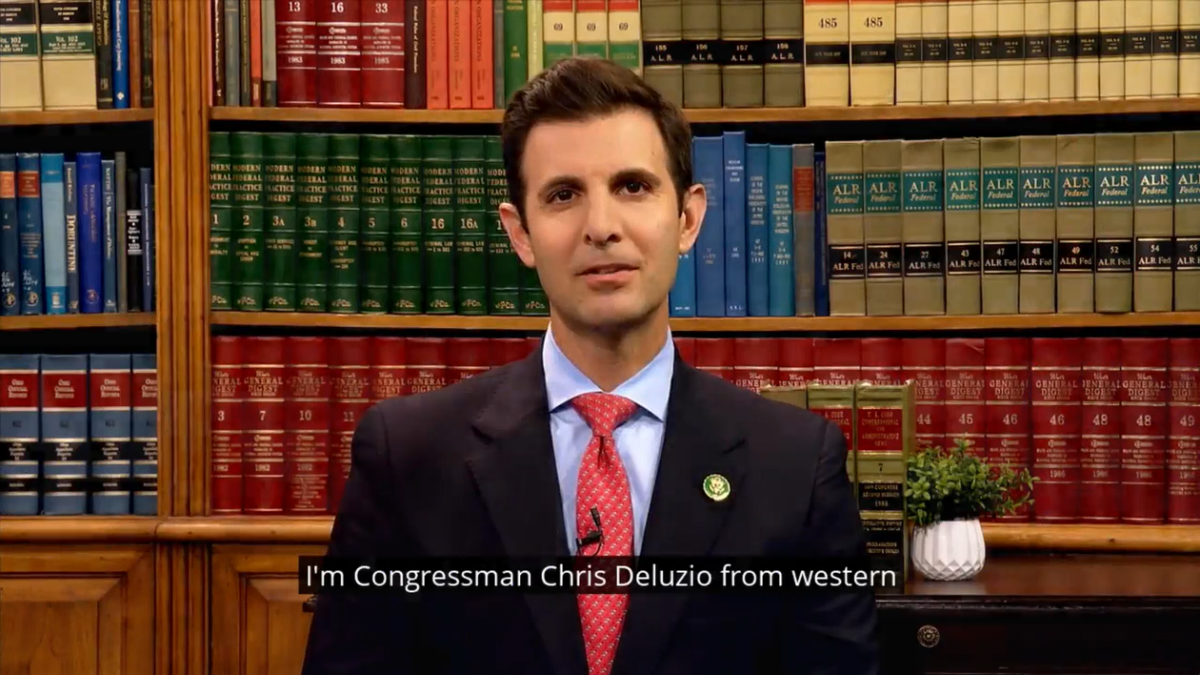 Congressman Deluzio sits in front of a bookcase