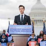 A photo of Congressman Deluzio speaking at a podium in front of the U.S. Capitol with a sign that says "Speak out against political violence"