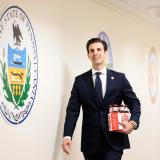 A photo of Congressman Deluzio proudly carrying a six-pack of Iron City beers
