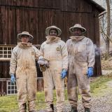 A photo of the beekeepers wearing beekeeper suits