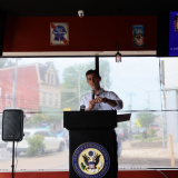 Rep. Deluzio stands behind a podium and gives remarks