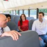 A photo of Congressman Deluzio sitting and talking and smiling while riding an Electric School Bus