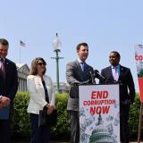 A photo of Congressman Deluzio and colleagues speaking in front of the Capitol at a podium with a sign that says "End Corruption Now"