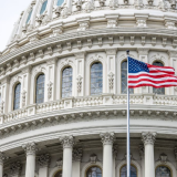 An American flag flies in front of the Capitol Dome