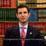 Congressman Deluzio sits in front of a bookcase