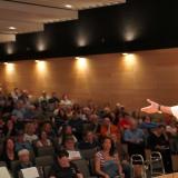 A photo of Congressman Deluzio speaking on stage to an auditorium of hundreds of people