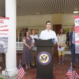 Rep. Deluzio stands behind a podium speaking at a press conference