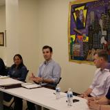 A photo of Congressman Deluzio sitting at a table next to labor union leaders at a roundtable discussion