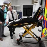 A photo of Congressman examining a stretcher with the EMS Chief
