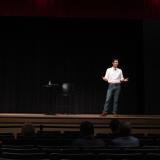 Rep. Deluzio stands on a stage and speaks to an audience