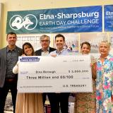 A photo of Congressman Deluzio and local leaders holding a large federal check for $3 million for the Etna Center for Community