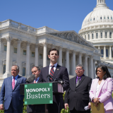 Congressman Deluzio speaking at a podium in front of the U.S. Capitol building, joined by colleagues and small business owners